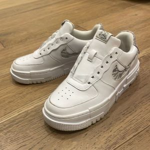 White Air Force Ones with zebra print swoosh.